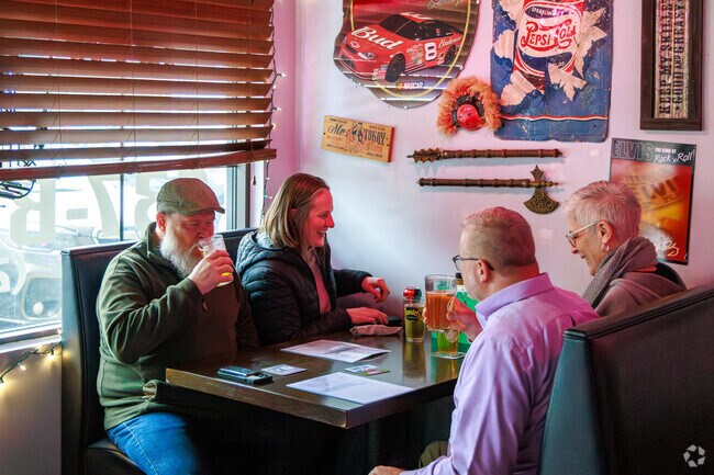 Patrons enjoy their drinks with a lively mood at Gino's Cheesesteak & Onion in Fayetteville.