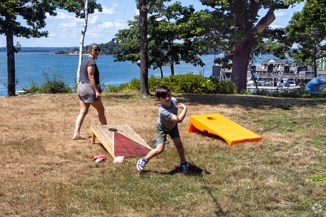 A mother and son play Corn Hole on Peaks Island.