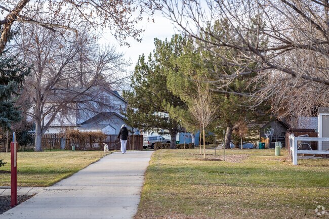 Dog Walkers enjoy the open green area at Blet and Bebe's Park in Columbine Meadows, Broomfield, Colorado.