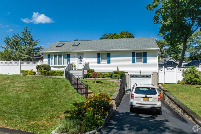 This Rocky Point ranch features a garage under.