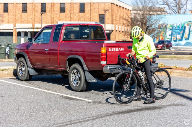 A biker plans his route around Newton on a sunny day.