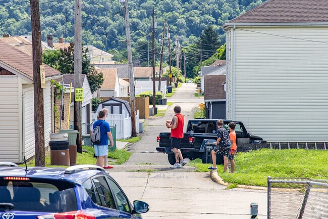 Toronto has a small-town community spirit with kids playing football in the street.