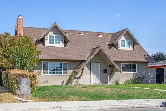 Typical homes in Wible Orchard feature grassy lawns set against sidewalks.