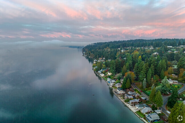The sky glows at sunrise over Wauna's coastline, seen from the Purdy Bridge on the 302.