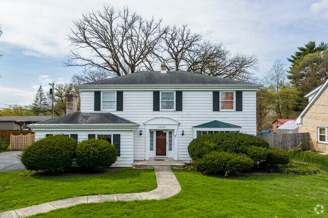 Colonial styled homes with green hedges elevate Lottaville.