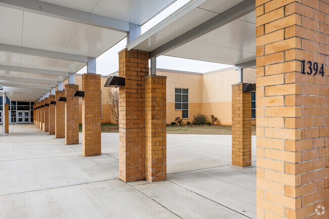 Paisley IB Magnet School features a covered walkway for drop-offs and pickups.