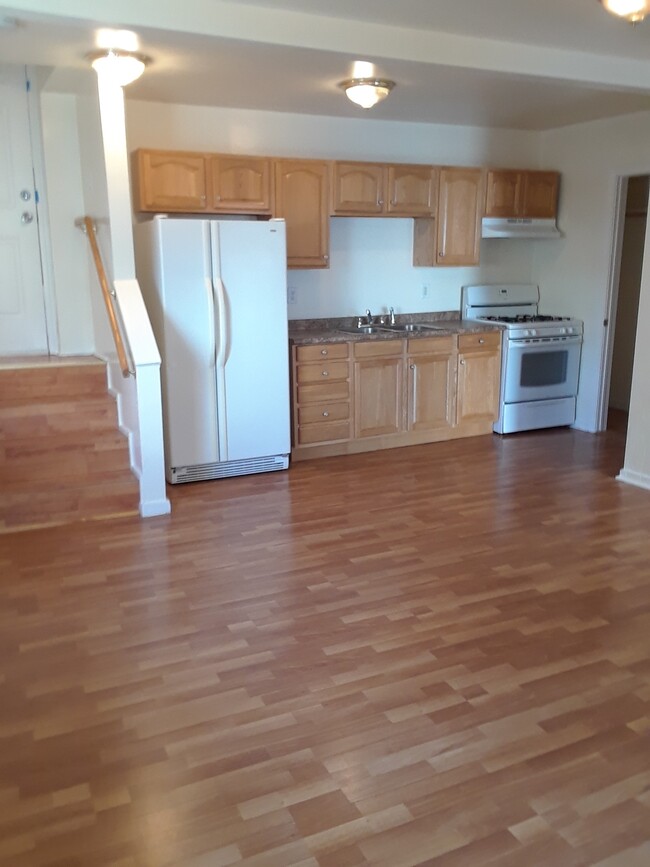 Kitchen with full size refrigerator and gas cooking stove
