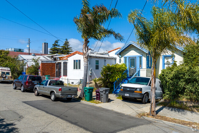 Many homes in Golden Gate have small front yards with blooming bushes and tropical trees.