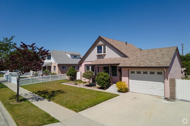 Traditional Midway City homes feature green lawns and private driveways.