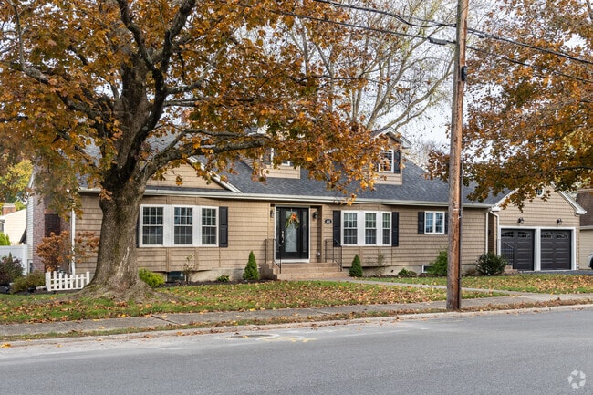 A North End cape cod with dormer windows and attached garage.