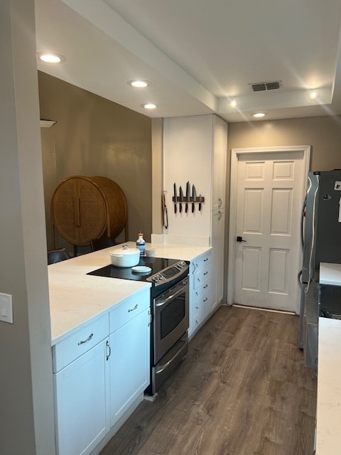 Bright kitchen with white cabinets and open flow to dining.