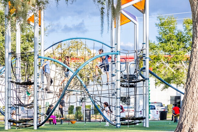 Kids of all ages climb and play at the newly built playground in Ferran Park in Eustis.