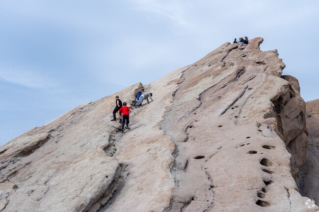 Kids climb to the top of a rock formation at Vasquez Rocks in Agua Dulce.