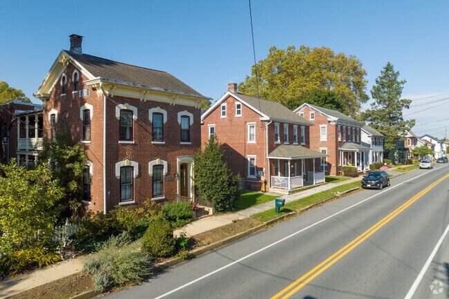 Three brick colonial homes line High Street in the middle of Maytown.