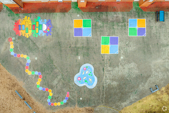 Students leave behind chalk murals on the pavement at McClellan Elementary School.