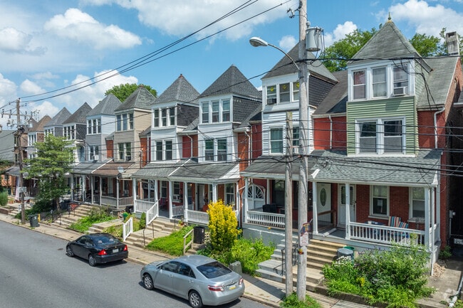 Historic three-story row homes in Musser Park offer spacious front porches.