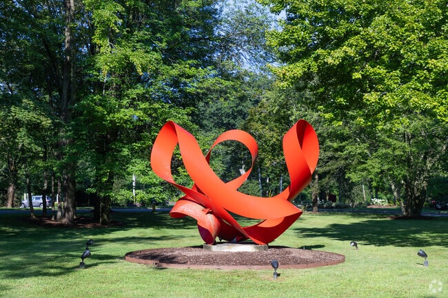 Armonk blends tradition and innovation with its striking red metal sculpture.