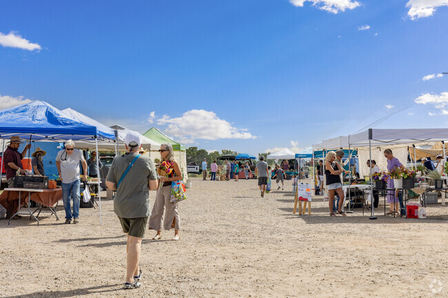 People peruse the goods at a local farmers market near Old Las Vegas Corridor.
