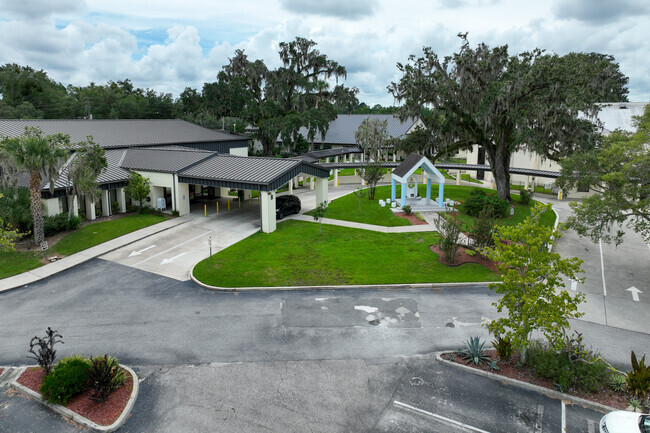 Blessed Trinity School drop off area has an island with a catholic display.