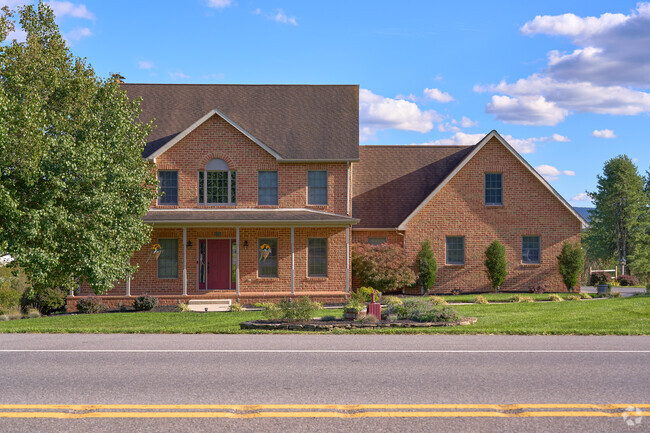 A modern brick colonial-style home sits along Leitersburg Pike.