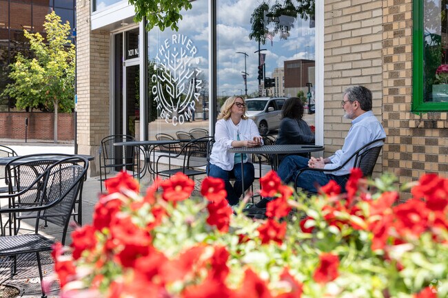 Locals can chat at a table outdoors at River Coffee Company by Wabash Crossing.
