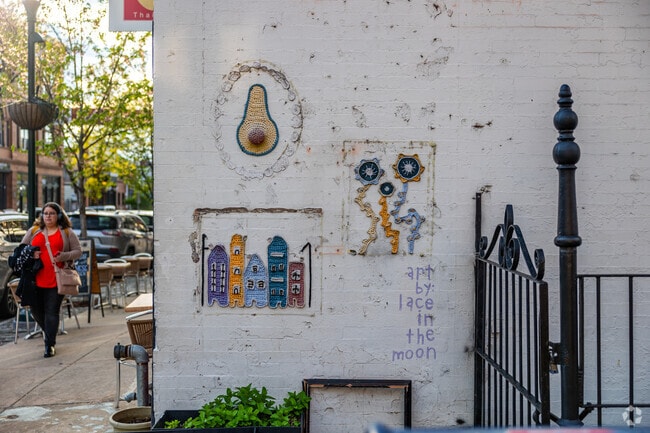 Hand crocheted art pieces add character to Manayunk streets during sunset.