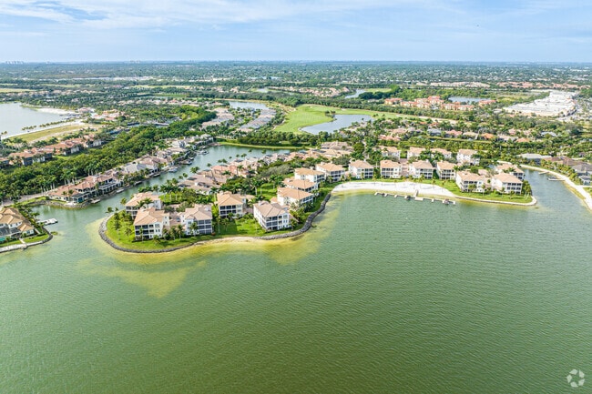 Canopies of Palms Grace Azure Lakes, Unfolding Miromar Lakes' Aerial Beauty.