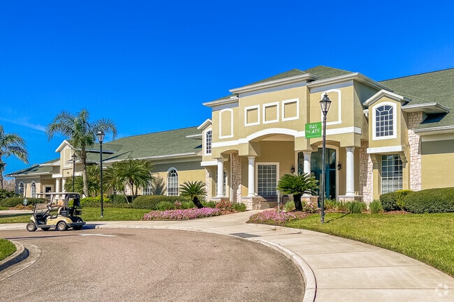 Clubhouse with golfcart parked in front of Heritage Isles Golf & Country Club.