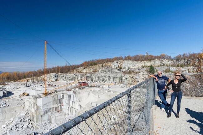 Folks listen to the tour guide at the Rock of Ages granite quarry tour near South Barre.