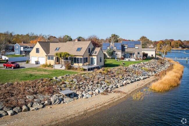 A beautiful row of homes offers stunning waterfront views in Somerset Historic Village, MA.
