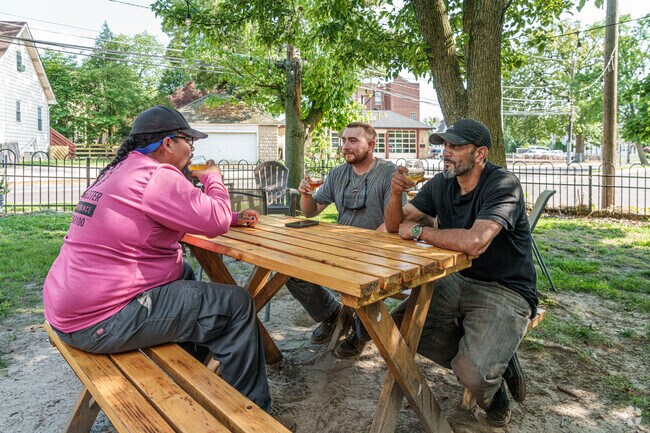 Friends have some laughs as they sip craft beer at Eclipse Brewery in Merchantville.