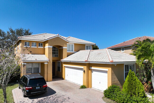 Spanish revival home with two garages in Wyndham Lakes.