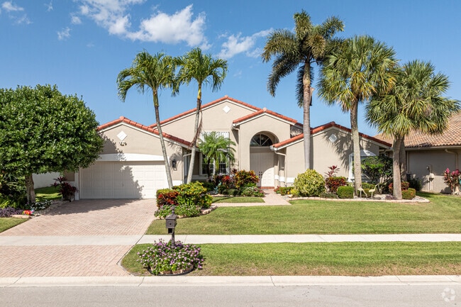 Tall palm trees embellish the homes surrounding The Cascades.