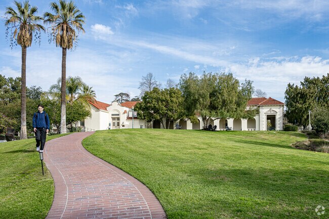 A student walking down a winding path at Whittier College, Whittier.