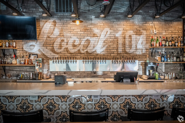 Grab a delicious slice of pizza with a cold refreshing beer on tap at Local 104 in Turtle Rock.