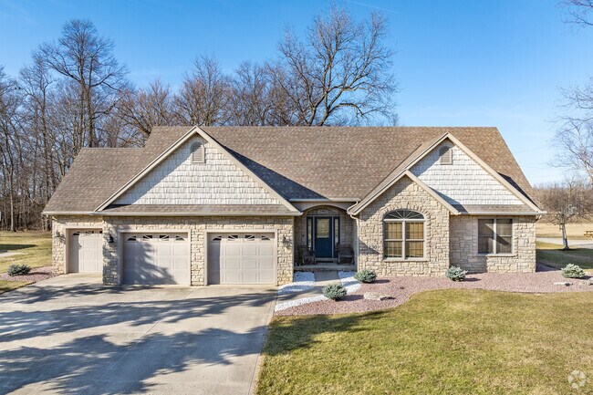 A ranch style home in Bucyrus, Ohio features a thee-car garage.