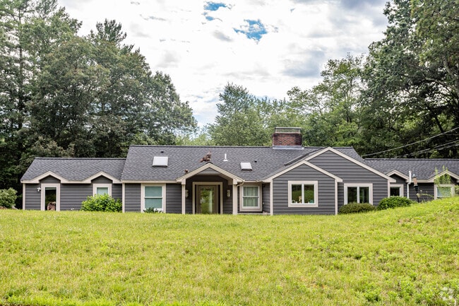 A mama turkey and her babies sit comfortably above a ranch-style home in Carlisle.