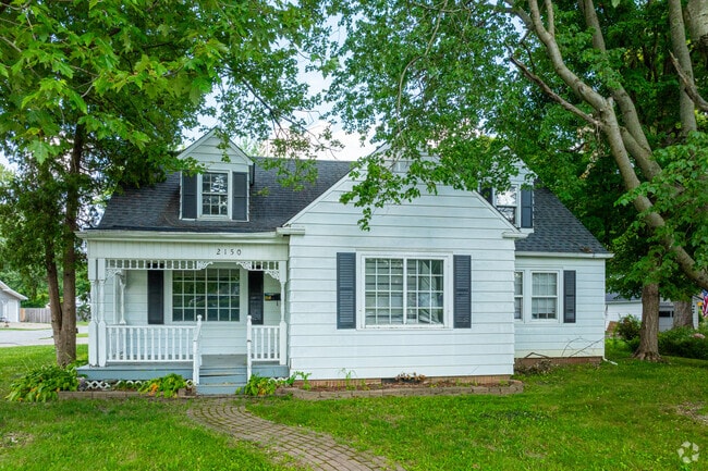 This Bon Air Cape Cod enjoys the shade of mature trees.