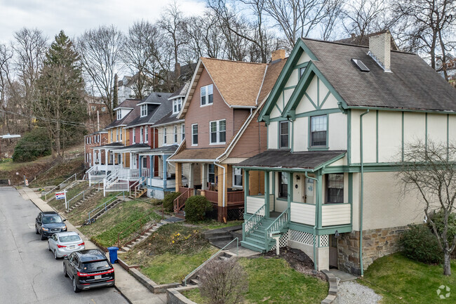 A row of houses sit up in elevation off the streets in Crafton.