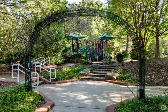 Maria Dorrel Park offers shaded play areas beneath a canopy of trees in Crossroads.