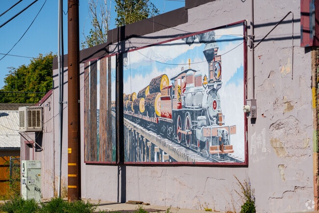 A train mural decorates a building in downtown Weed.
