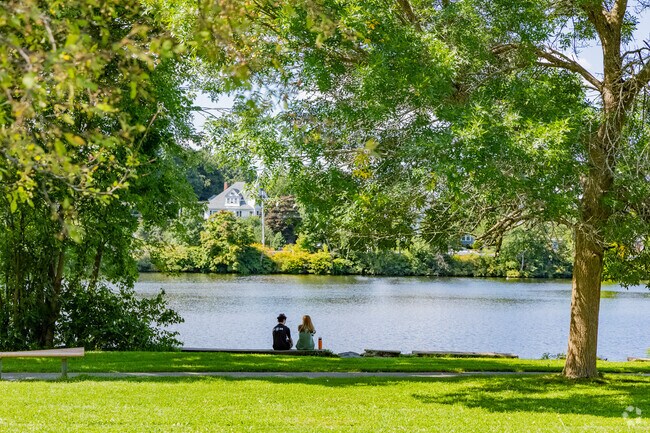 A couple enjoys a quiet moment on the shore of the Merrimack River in Lowell.