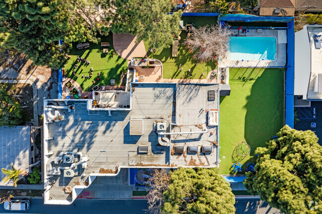 Amenities at Manhattan Academy in Manhattan Beach feature outdoor play areas and a pool.