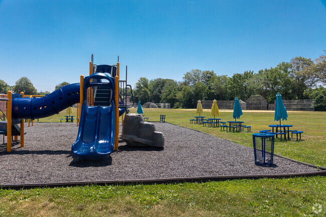 The playground at Brielle Elementary School is in a park like setting.