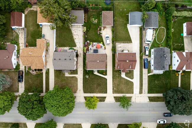 Rows of homes and garages are bookended by green lawns.