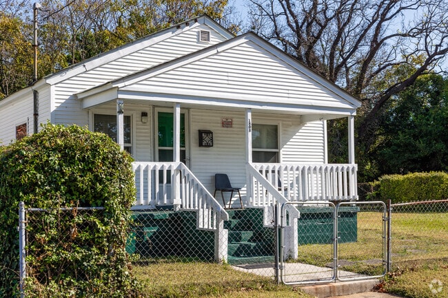 This home in Marshall features an elevated front deck and pediment.