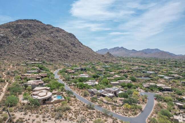 Subdivisions in the Pinnacle Peak neighborhood are surrounded by mountain ranges.