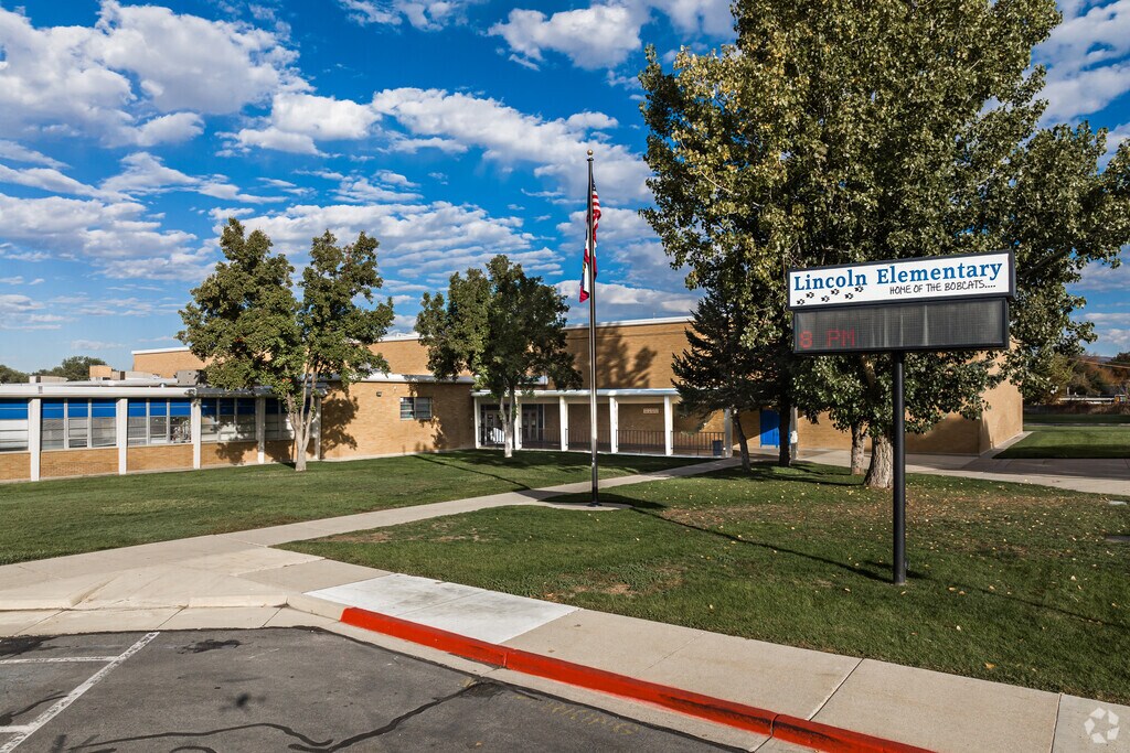 An electronic sign and American flag stand near the entrance of Lincoln Elementary School.