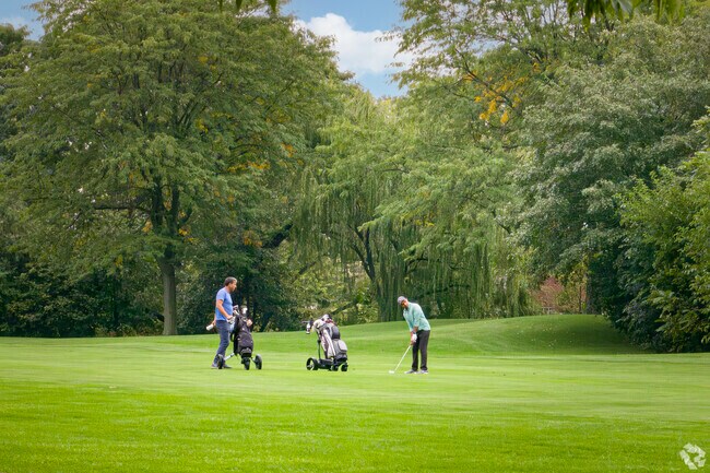Friends swing for the green at the Deerfield Golf Club.