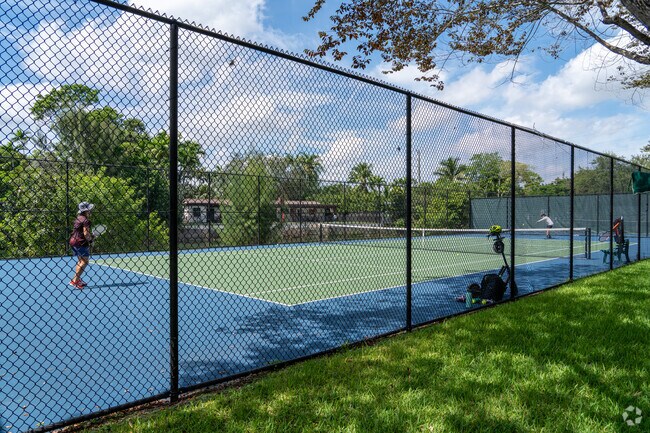 People enjoy playing tennis at Brewer Park in South Miami.